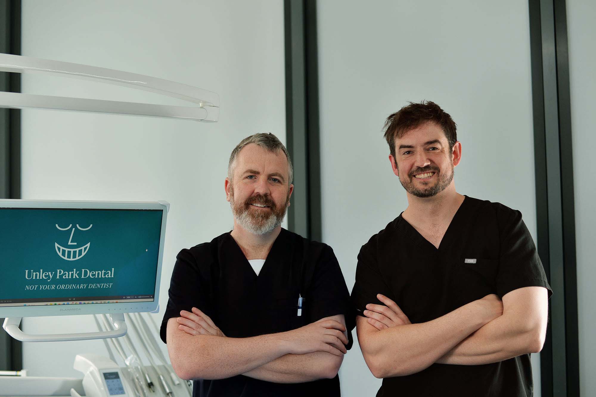 Unley Park Dentists Jarrad and Ben smiling in their clinic