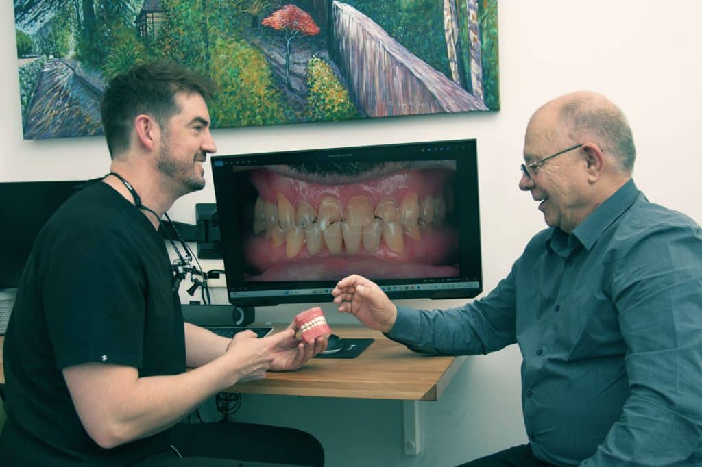 Dr. Jarrad and a patient smiling at a desk