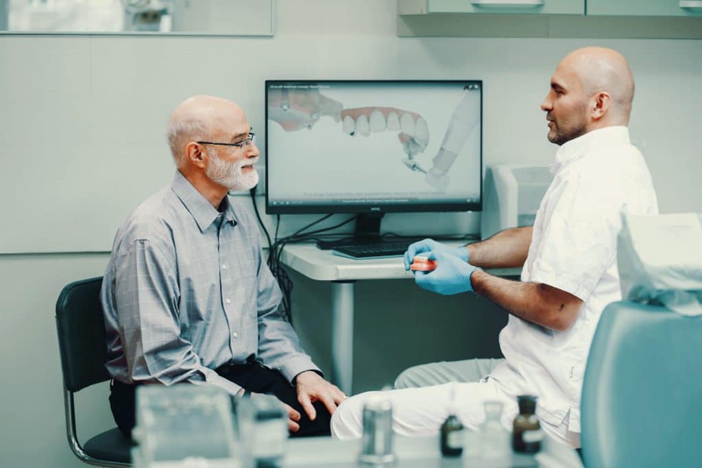 A patient learning about All-on-4 Dental Implants